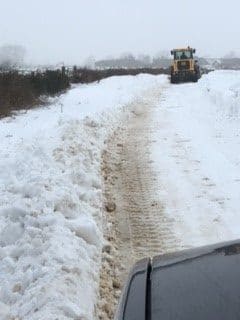 Snow clearance vehicle on road covered in thick snow