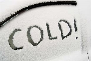 The word "COLD" written on snowy windscreen