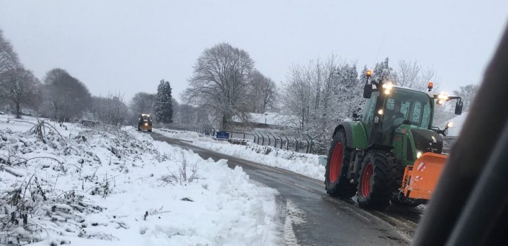 Gritting after the ploughs have cleared the snow on a Gloucestershire business park