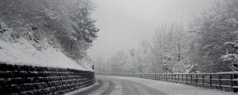 Cleared road-icy scenery-stone wall-safety barrier